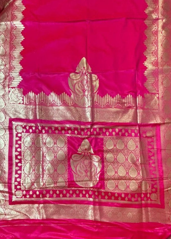 Pallu details of a Beautiful Rani Pink Banarasi Silk Saree with intricate golden zari work