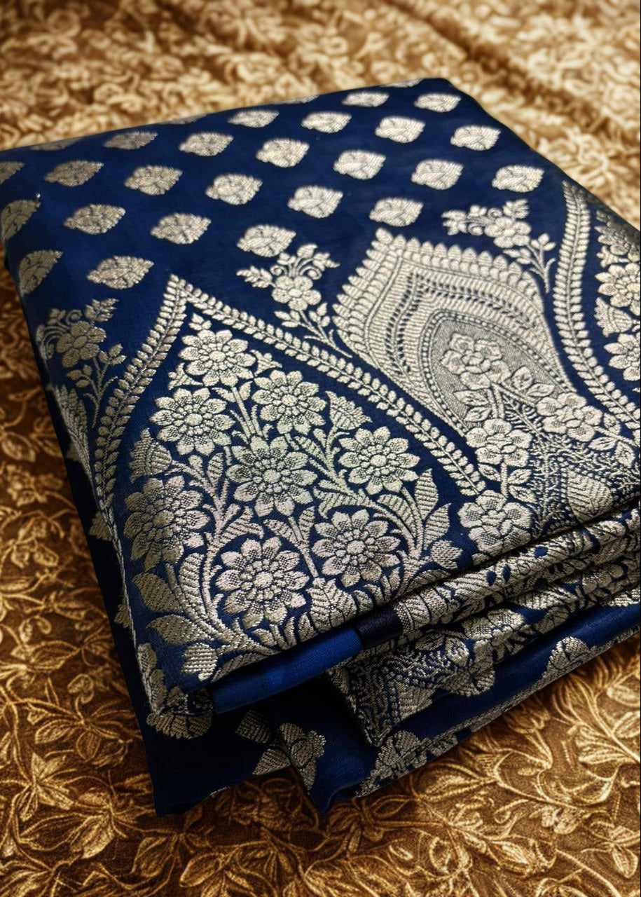 Beautiful navy blue Banarasi silk saree showcasing intricate zari work, placed over a yellow background