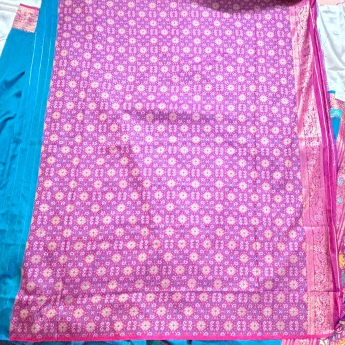 Magenta pink zari border on a peacock teal silk saree