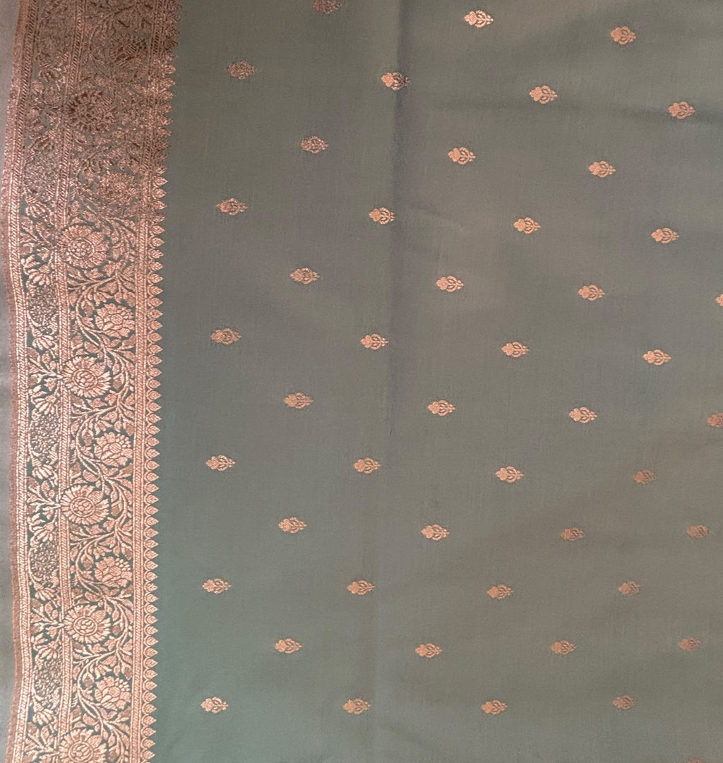 Delicate gold zari buttis woven on aqua blue Banarasi silk saree border