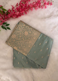 Close-up of large gold zari blooms and winding vines on aqua blue Banarasi pallu