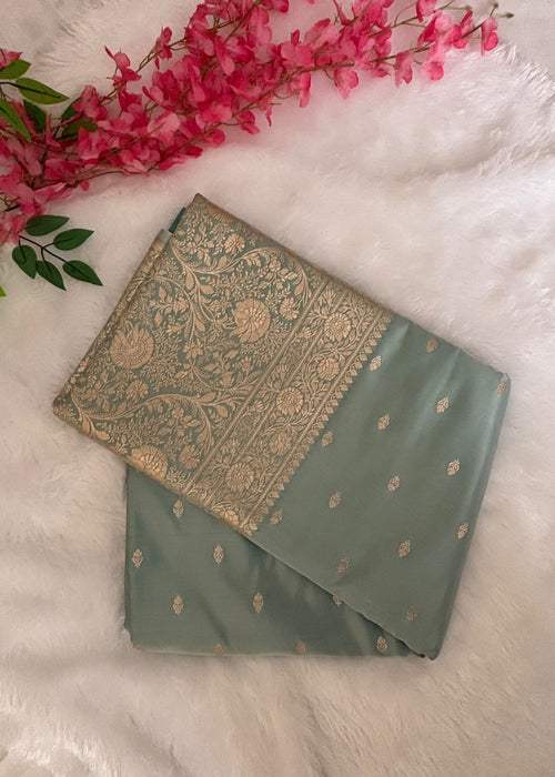 Close-up of large gold zari blooms and winding vines on aqua blue Banarasi pallu