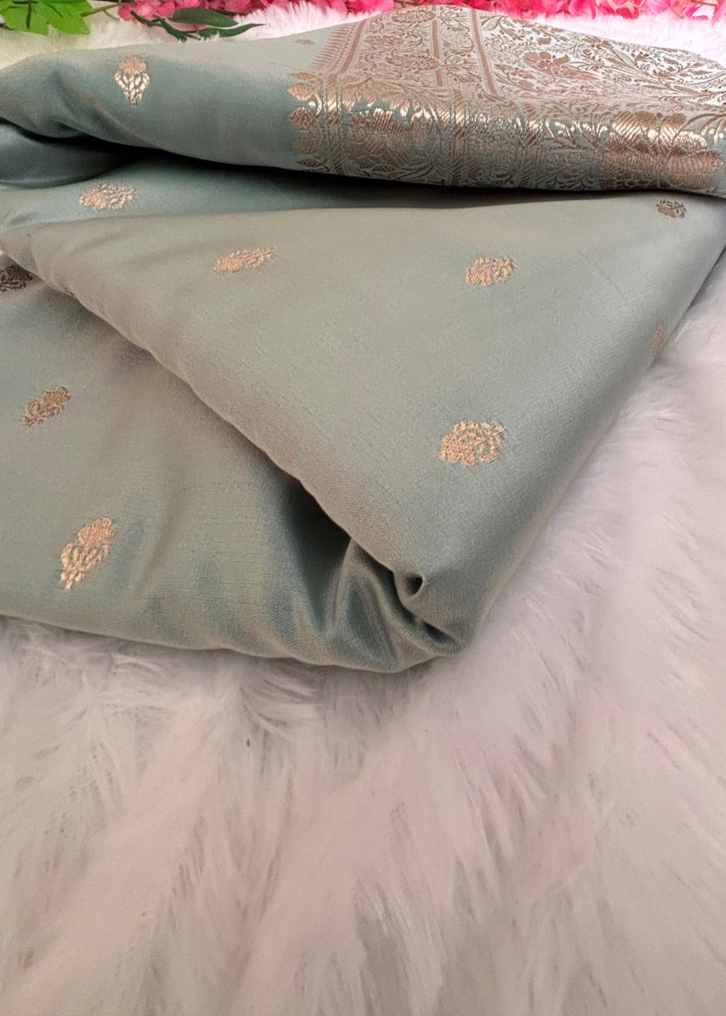 Delicate gold zari buttis woven on aqua blue Banarasi silk saree body