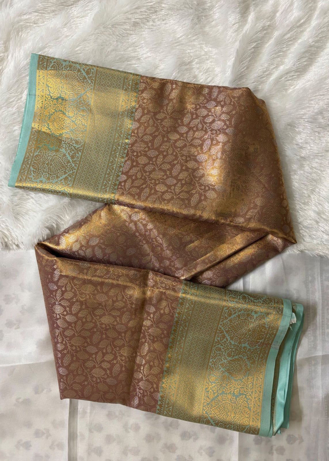 Close-up of all-over gold zari jaal weave on dusty rose Banarasi silk