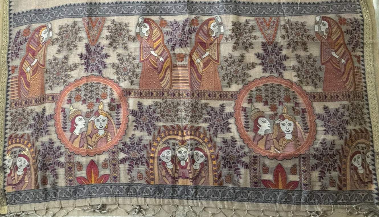 Full-length view of a woman elegantly posing in a lightweight, sandstone-beige Baluchari silk saree. The saree features delicate, small 'buti' motifs on the main body and an intricate, contrasting maroon and beige pallu with traditional mythological figures and narrative scenes. The style is classic and refined, perfect for festive or heritage wear