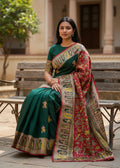 Woman in a traditional saree sitting on a bench outdoors