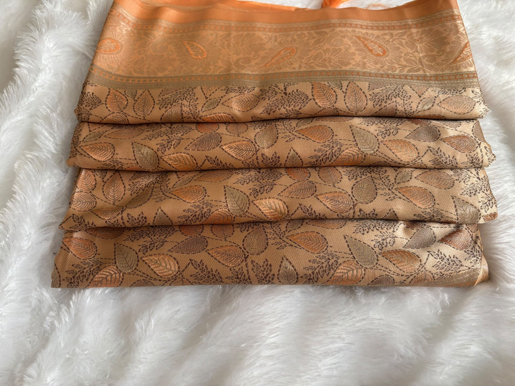 Close-up of copper zari pallu with architectural panels and paisley border on Banarasi saree