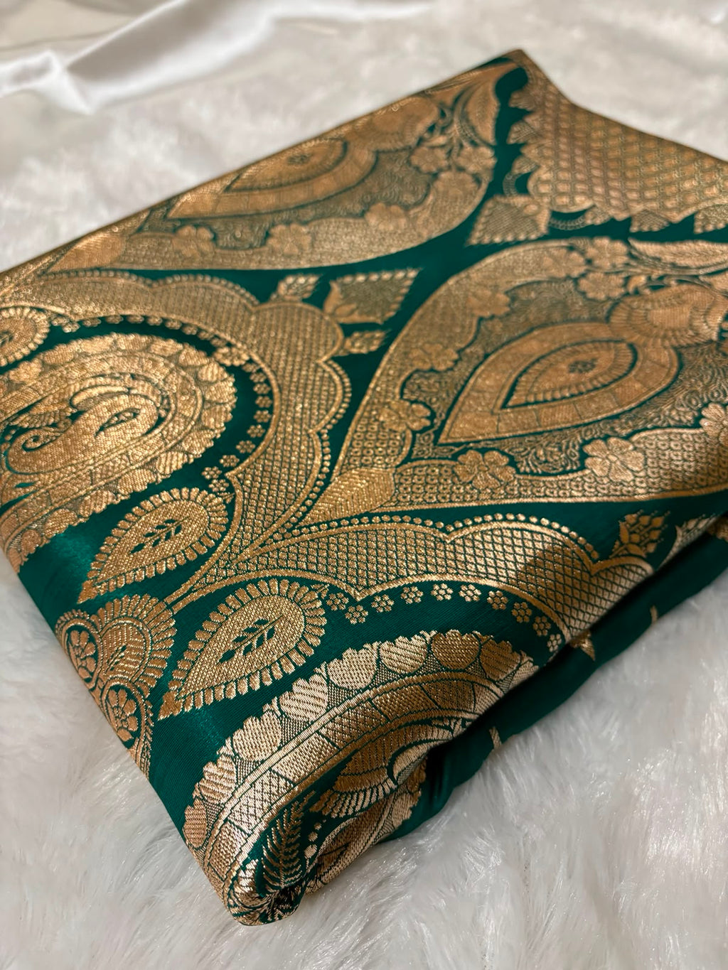 Oversized antique gold Mughal paisley zari pallu on teal green Banarasi silk saree — grand festive look