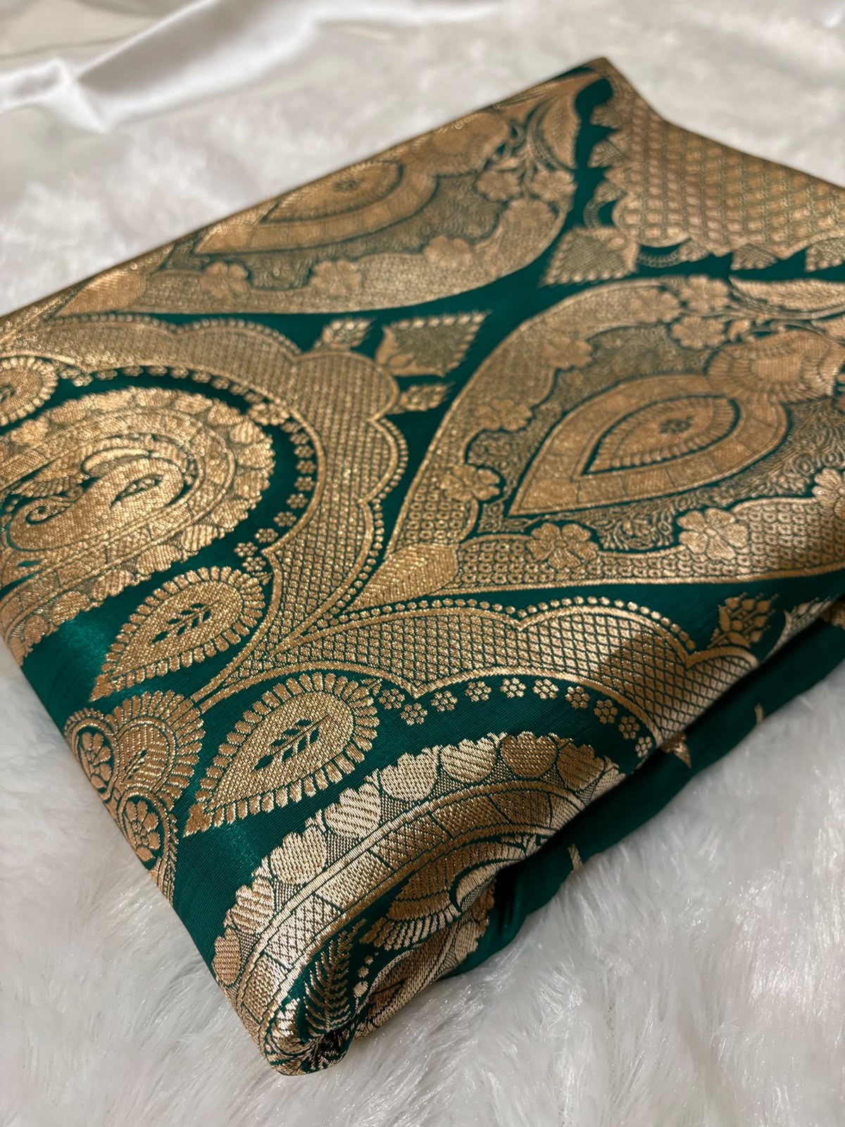 Oversized antique gold Mughal paisley zari pallu on teal green Banarasi silk saree — grand festive look