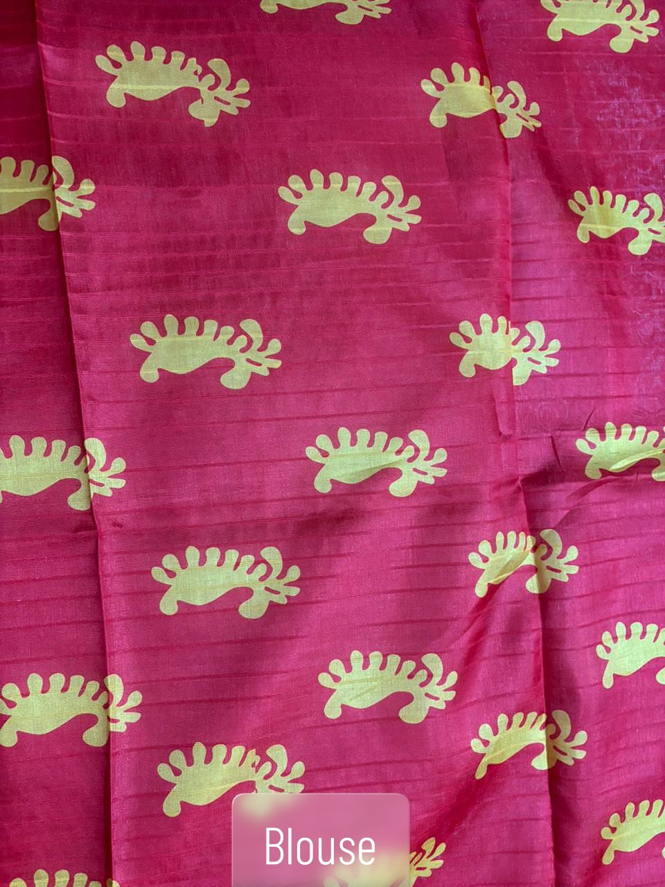Blouse design of a white handloom saree with Durga motif pallu, red border and traditional Bengali design, perfect for Pujo and festive occasions