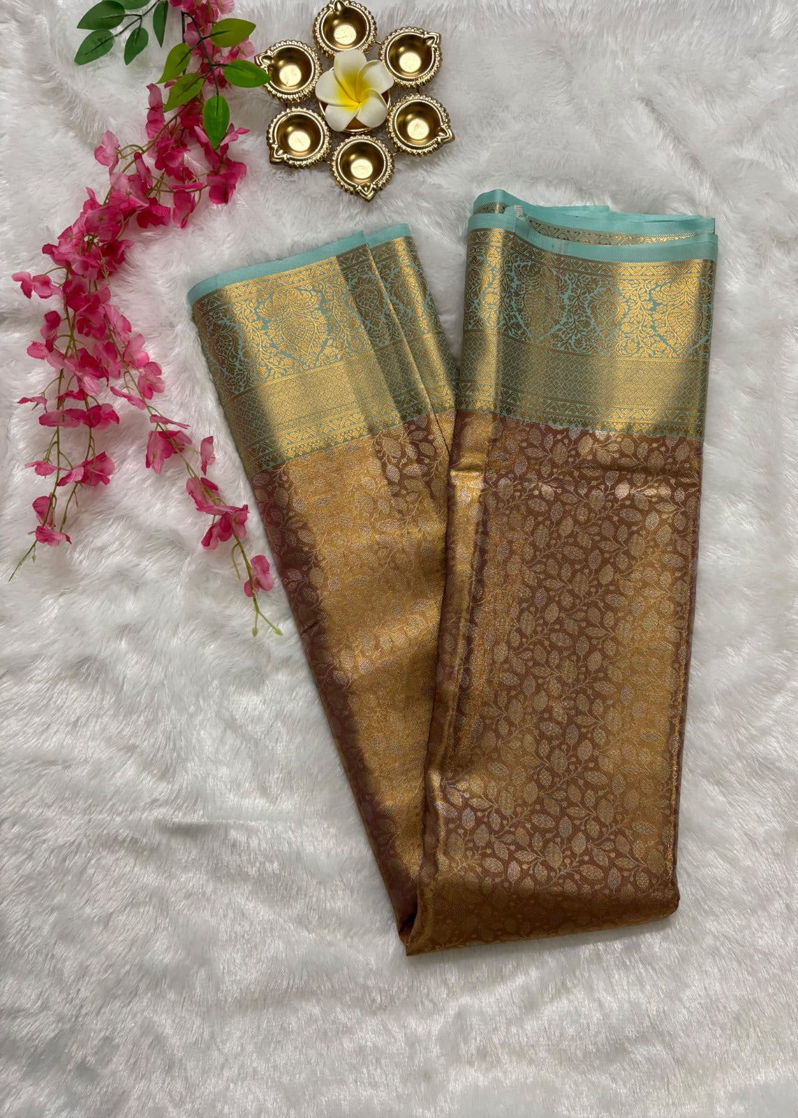 Close-up of all-over gold zari jaal weave on dusty rose Banarasi silk