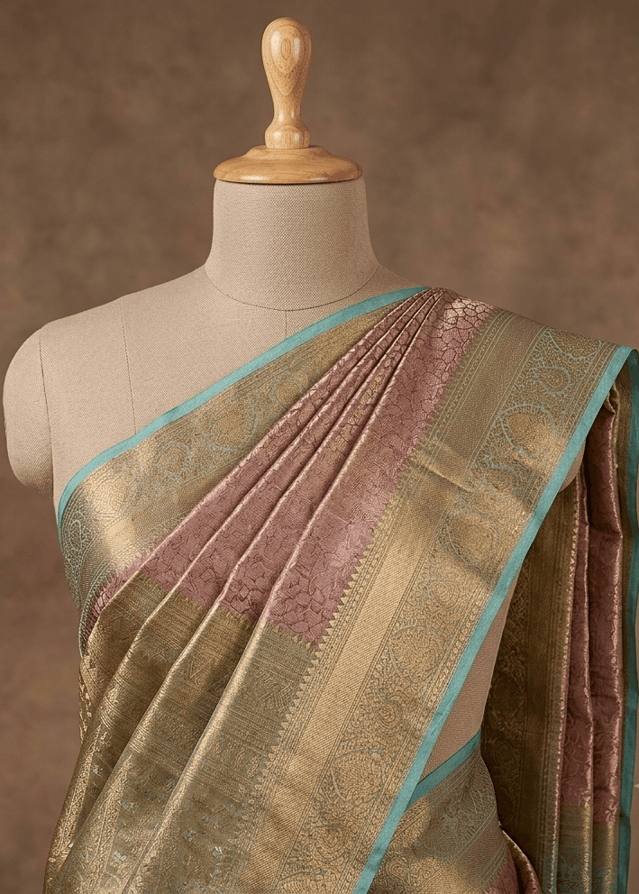 Dusty rose Banarasi silk saree with antique gold and sea green border draped on mannequin