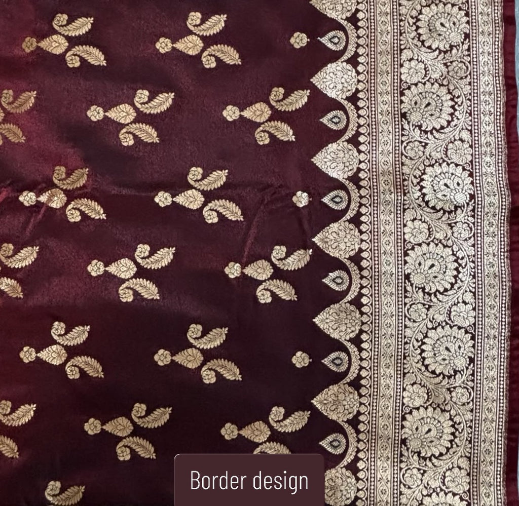 A close-up of a deep maroon Banarasi Silk Saree with metallic gold floral motifs and a wide ornate gold border design, labeled 'Border design' at the bottom.