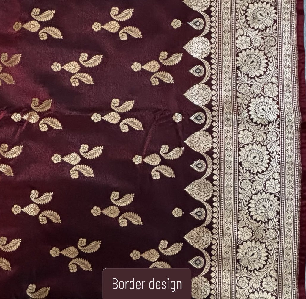 A close-up of a deep maroon Banarasi Silk Saree with metallic gold floral motifs and a wide ornate gold border design, labeled 'Border design' at the bottom.