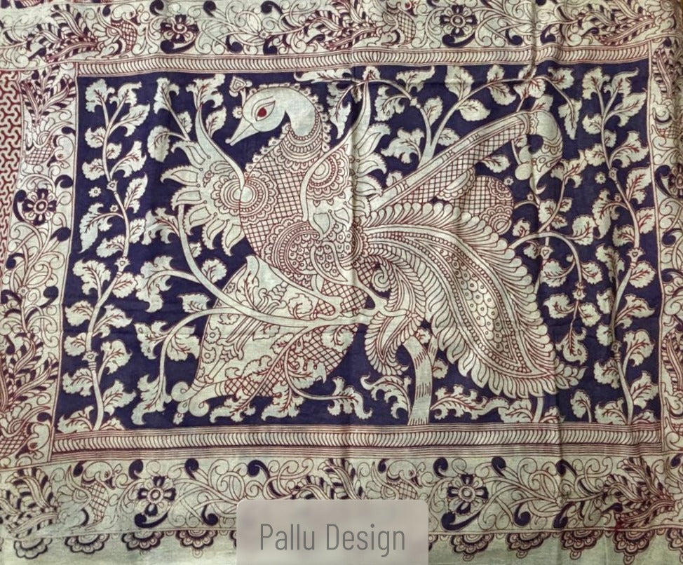 Mayur premium cotton Kalamkari saree with an intricate cream and rust floral body and a bold indigo blue peacock pallu