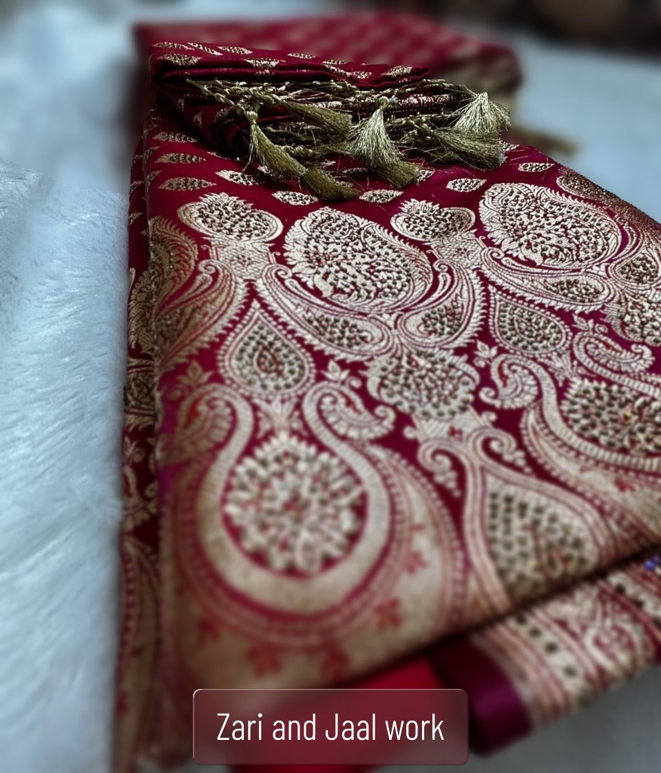 Closeup of antique gold zari buti weave on deep crimson Banarasi silk saree