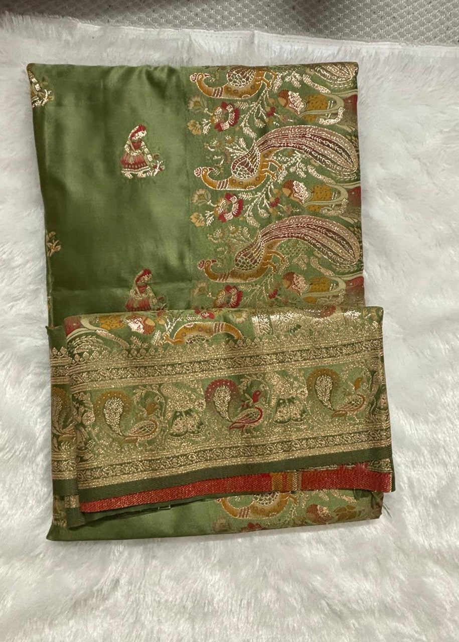  view of an imperial moss green Baluchari silk saree with delicate gold small buti motifs, a rich gold border, and a lavishly woven pallu depicting classic mythological figures and intricate royal patterns