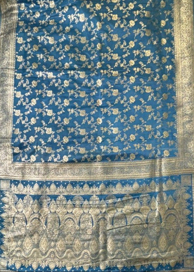 Intricate golden Zari work pallu design on a beautiful Teal blue color Banarasi Silk Saree