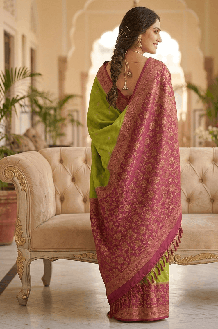 Wine magenta floral zari jaal pallu on a parrot green silk saree