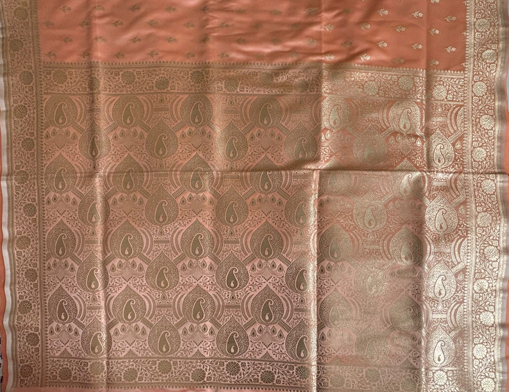 Close-up of rich gold zari paisley and jaal weave on peach Banarasi pallu