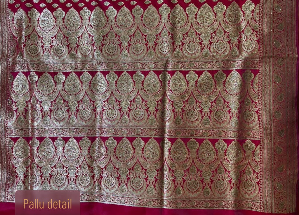 Intricate gold zari pallu detailing on red Minakari Banarasi silk saree