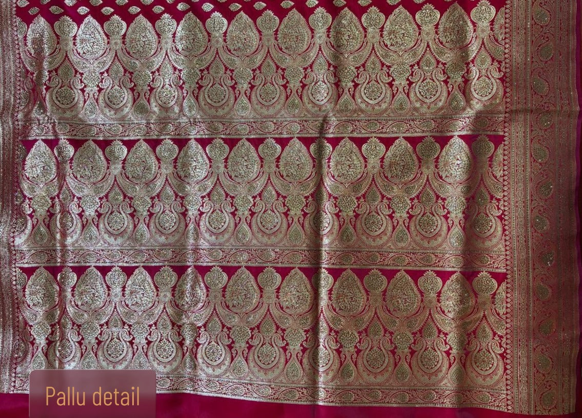Intricate gold zari pallu detailing on red Minakari Banarasi silk saree