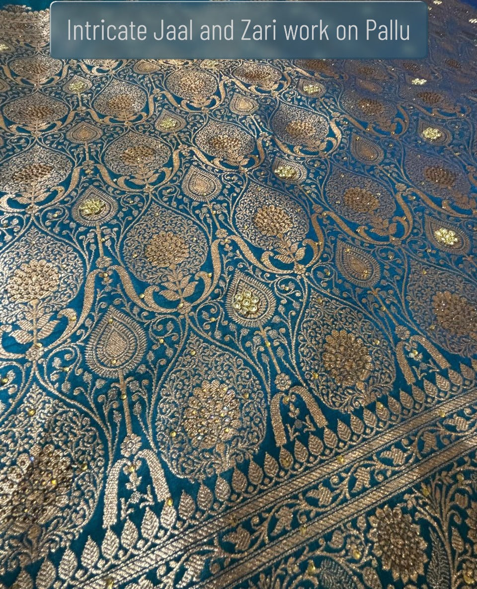 Ornate heavy golden zari pallu detailing on teal Banarasi silk saree