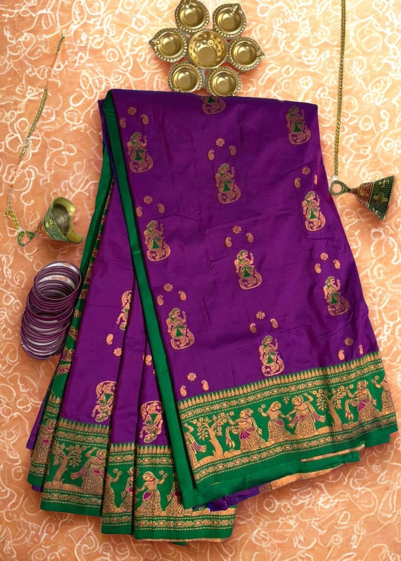 Rajrangini Baluchari saree border detail with intricate golden zari dance motifs on green border and purple silk body, authentic handcrafted Bengali silk saree