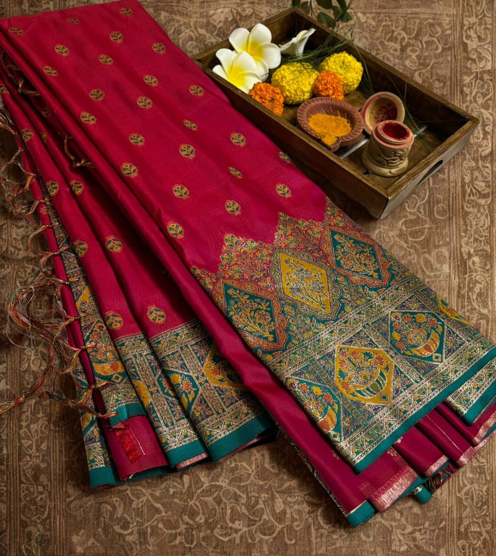 Red Baluchari saree with intricate patterns on a textured surface
