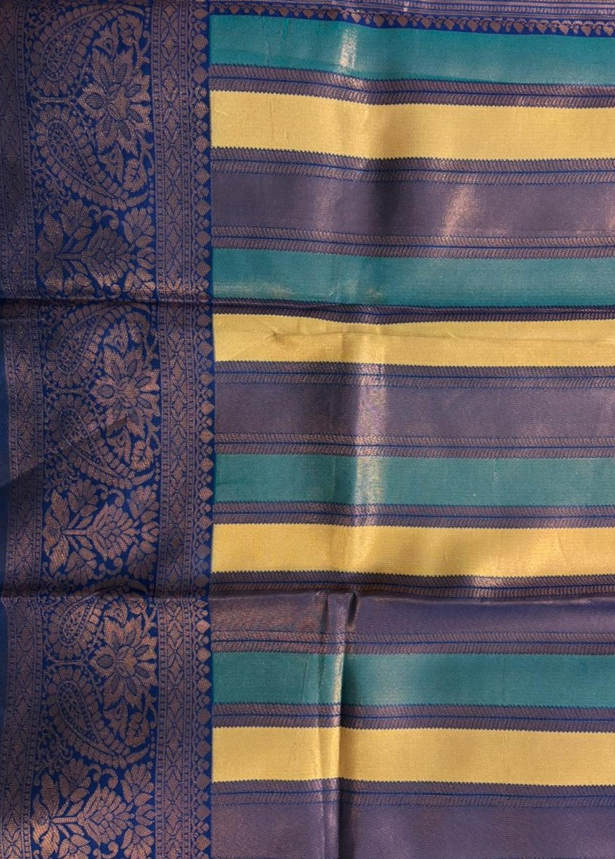 Woven zari paisley pallu on an indigo and mustard striped saree with royal blue border