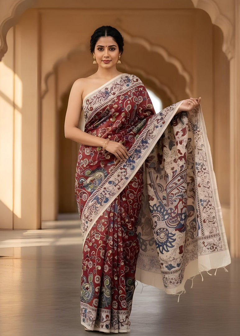 Woman wearing a traditional Kalamkari saree with intricate patterns in a warm-toned architectural setting