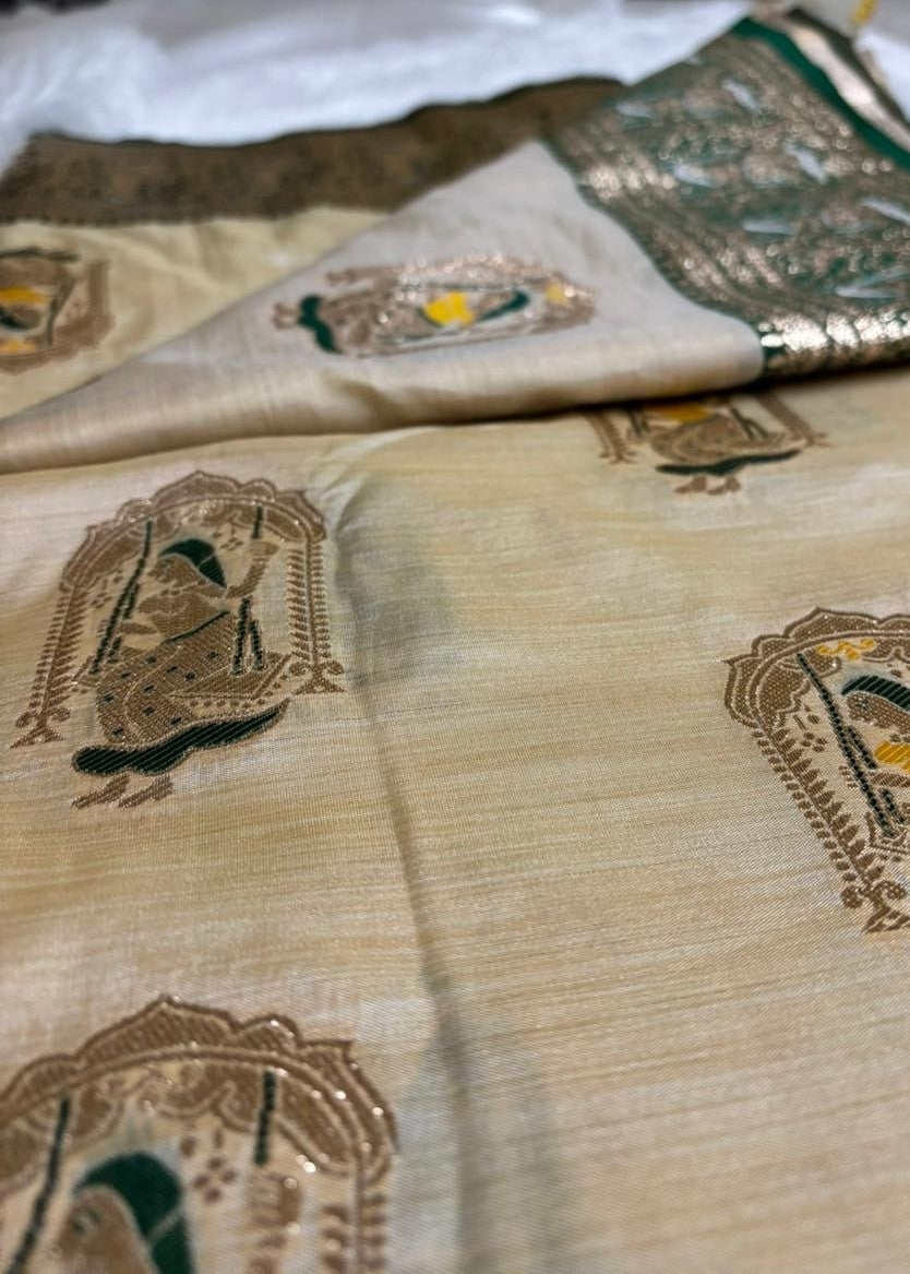 Beige fabric with intricate brown and green embroidery patterns