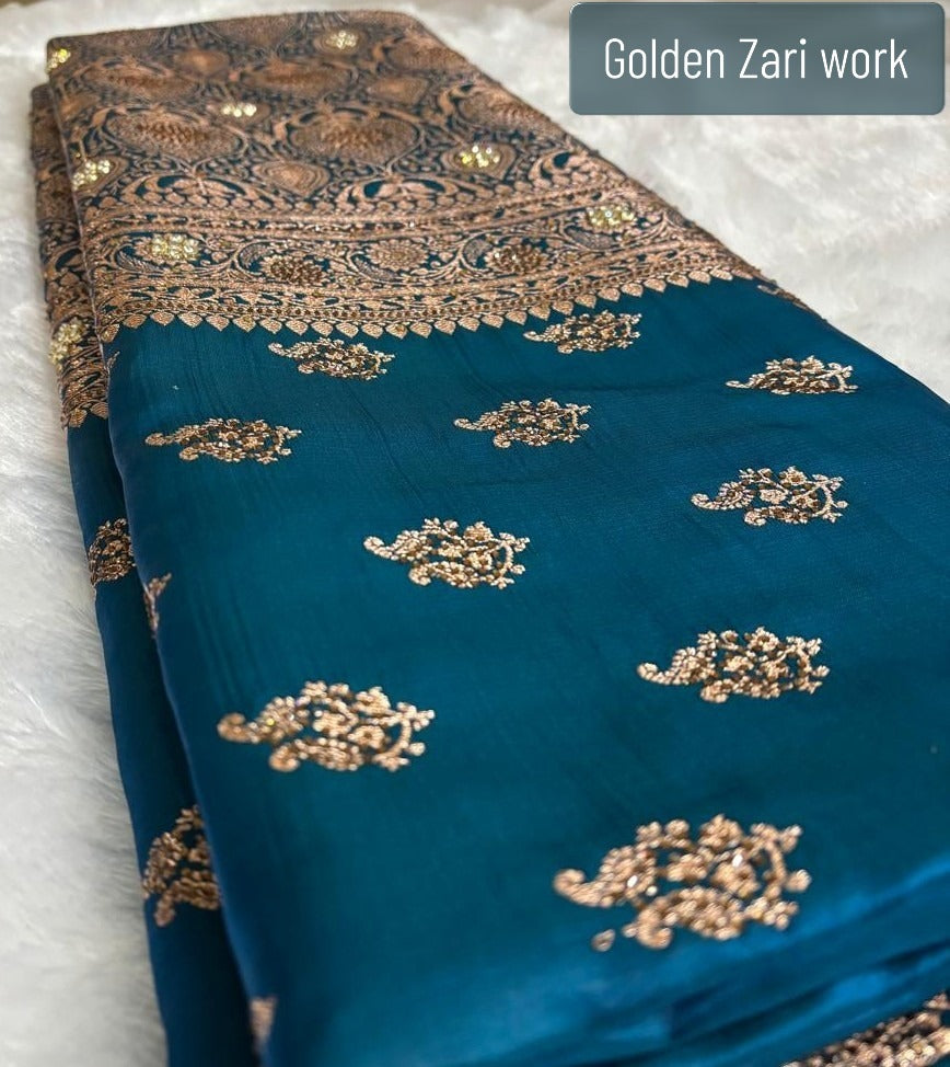 Teal blue Banarasi silk saree flat lay showing full golden zari buti and ornate pallu