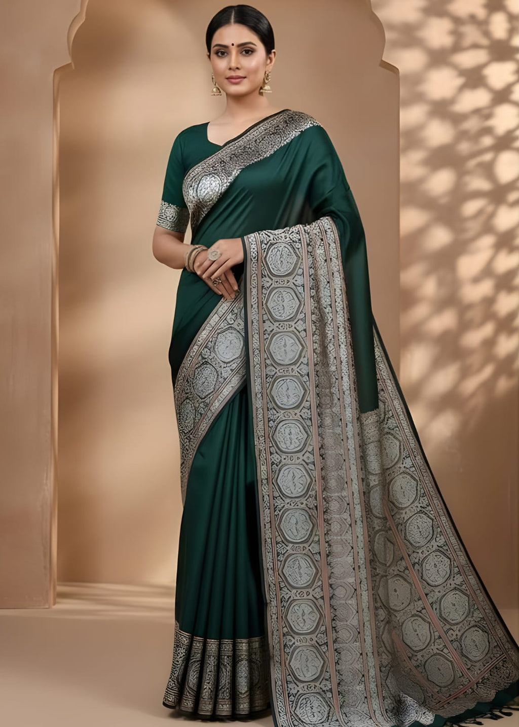 Woman wearing a green modal silk Azrakh saree with a patterned border against a beige background