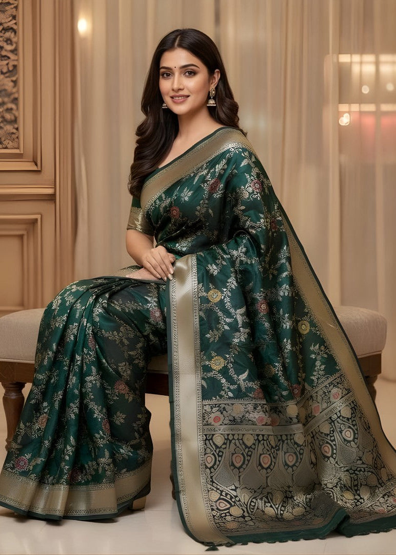 Woman wearing a green floral Banarasi saree with a beige background