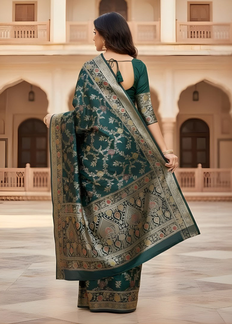 A woman in a traditional Banarasi saree standing in front of an architectural building
